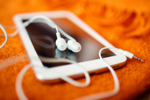 White earphones and tablet pc, close up photo, small dof